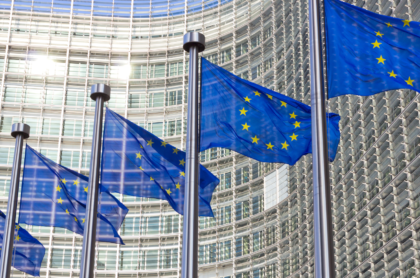 Picture of EU flags outside of buildings.